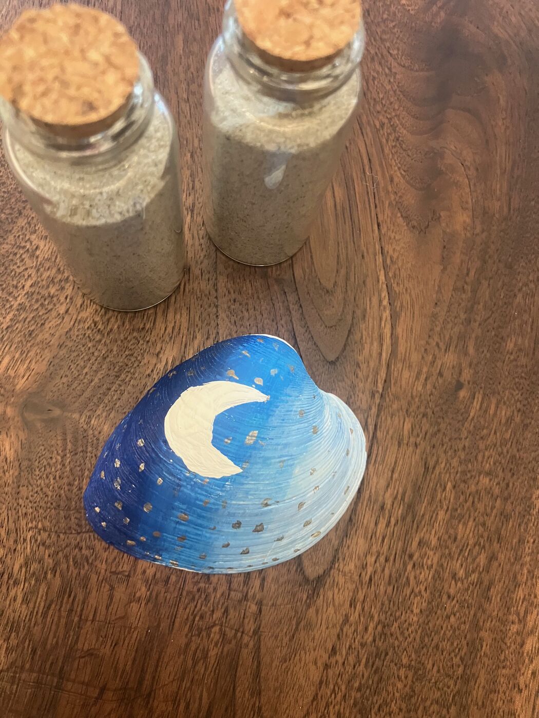 Navy blue shell hand-painted with a gold moon and stars