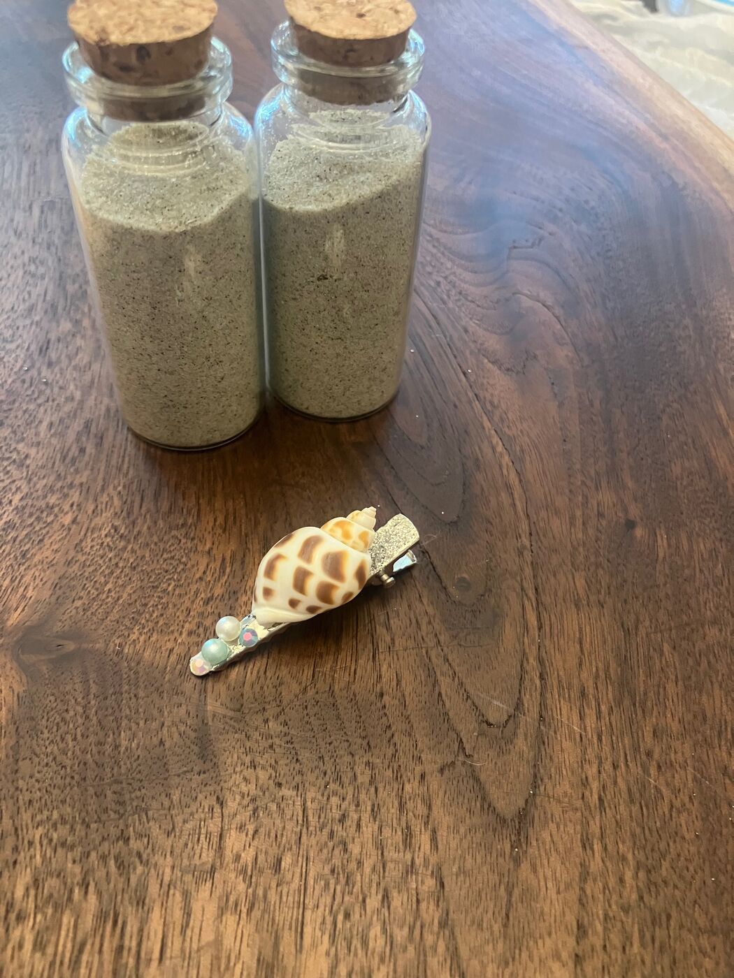 A petite beaded hair clip with a shell